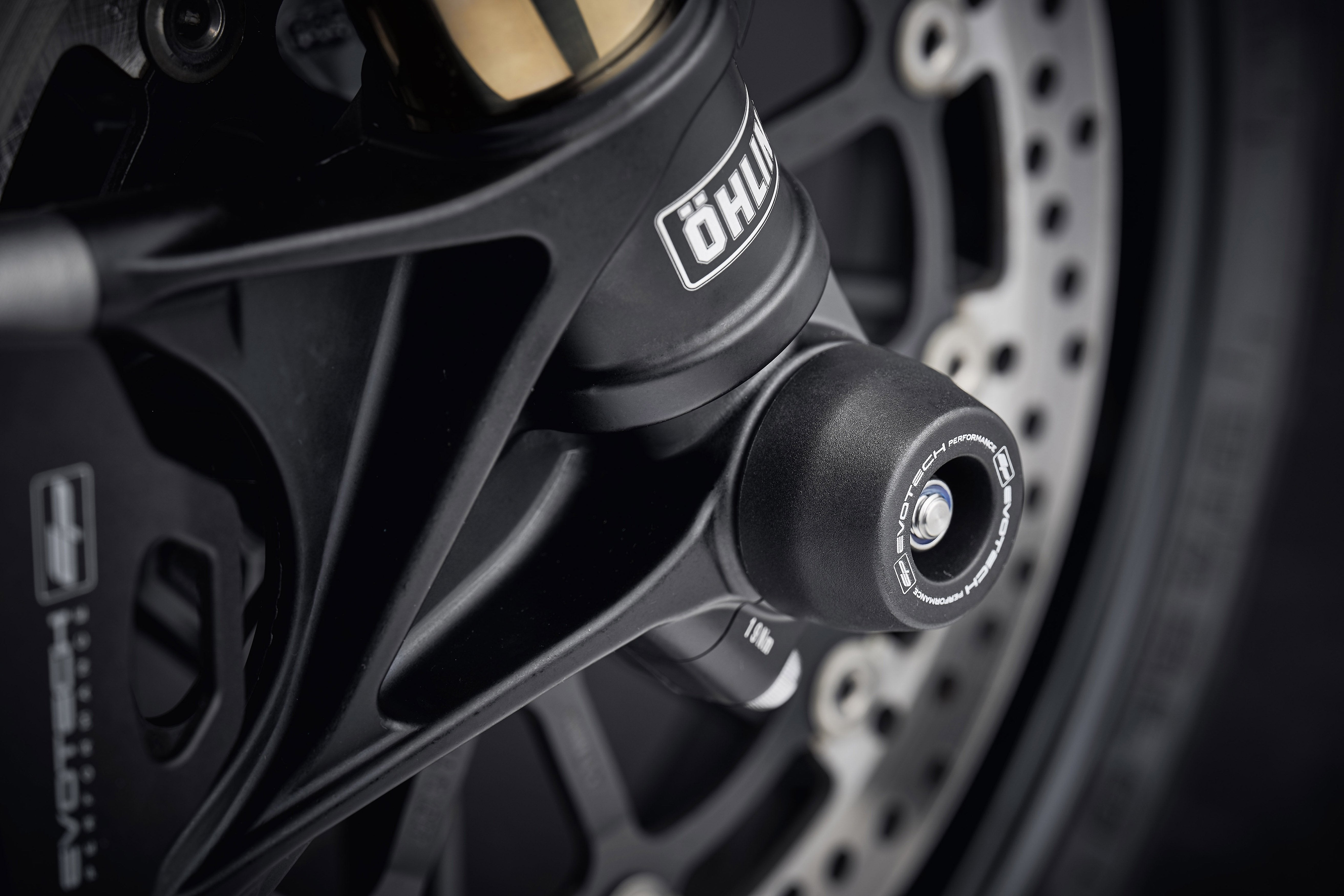 The offside front wheel of the Ducati V2 Bayliss 1st Champion 20th Anniversary with EP Spindle Bobbins Crash Protection fitted with brake calipers in sight.