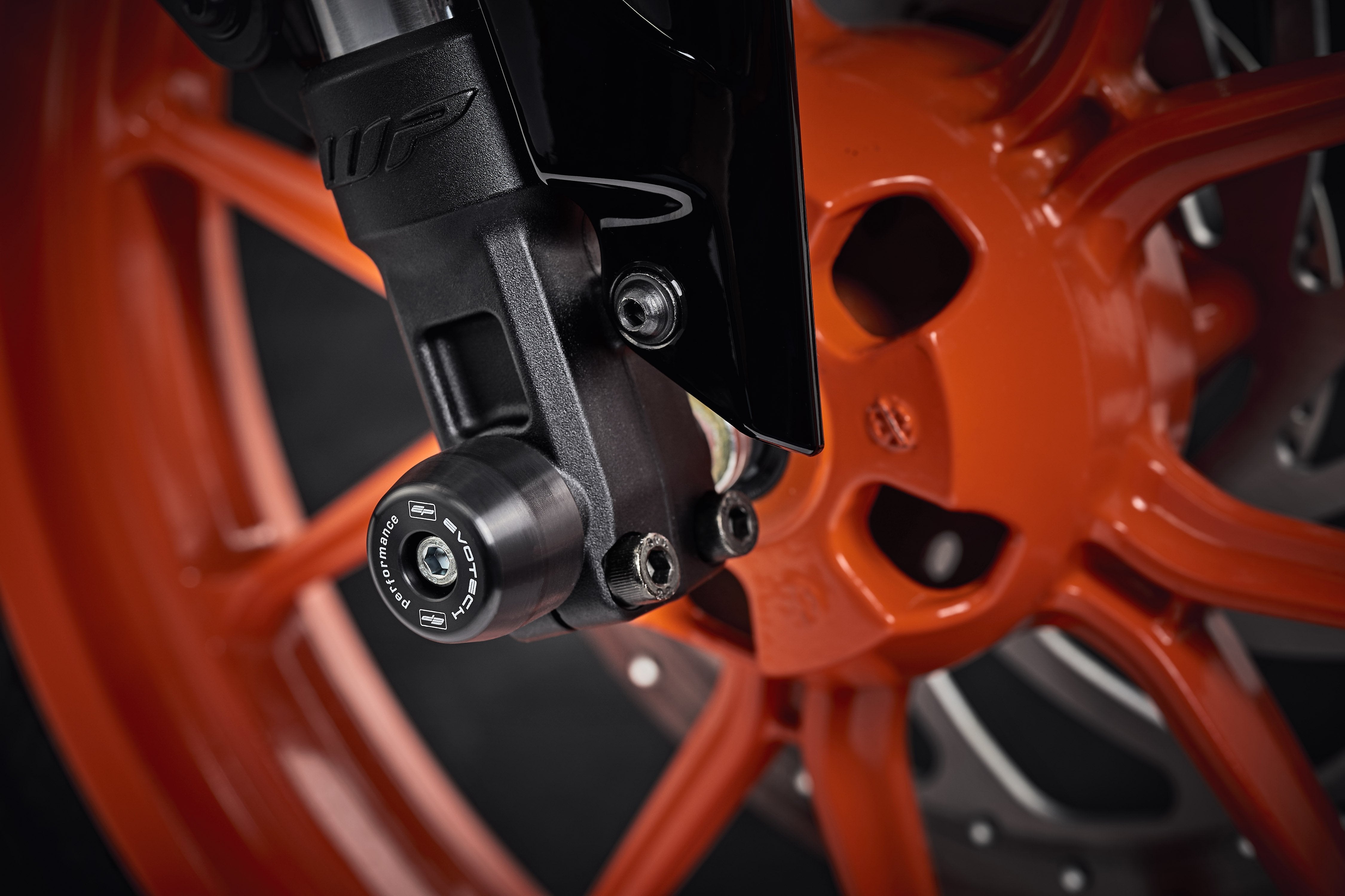 The lower front fork of the KTM 250 Duke with EP Front Spindle Bobbins securely attached, offering crash protection to the motorcycleâs front wheel.